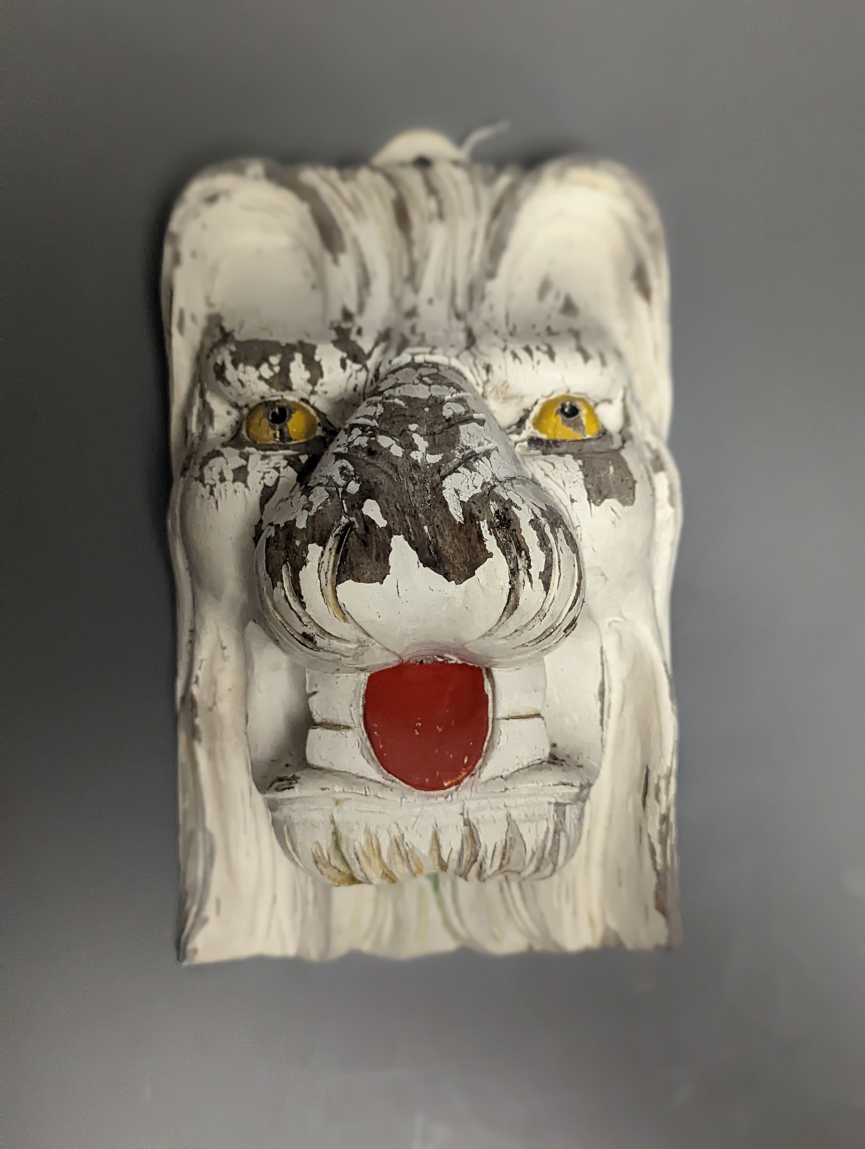 A hand carved painted wood lions head wall mount 24cm